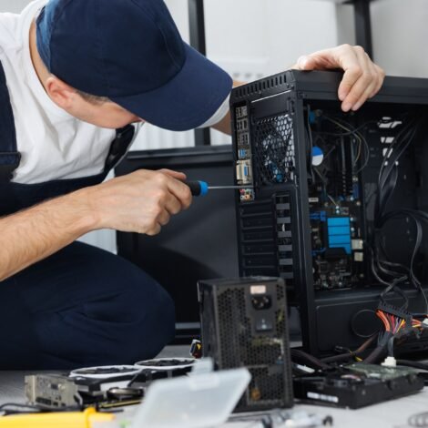 Diy Computer Repair Made Easy: Tips &Amp; Professional Help In Harwich 10 Closeup computer technician holding a screwdriver and repairing a pc.