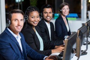 smiling call center team working at computers 2026 04 14 00 06 13 utc